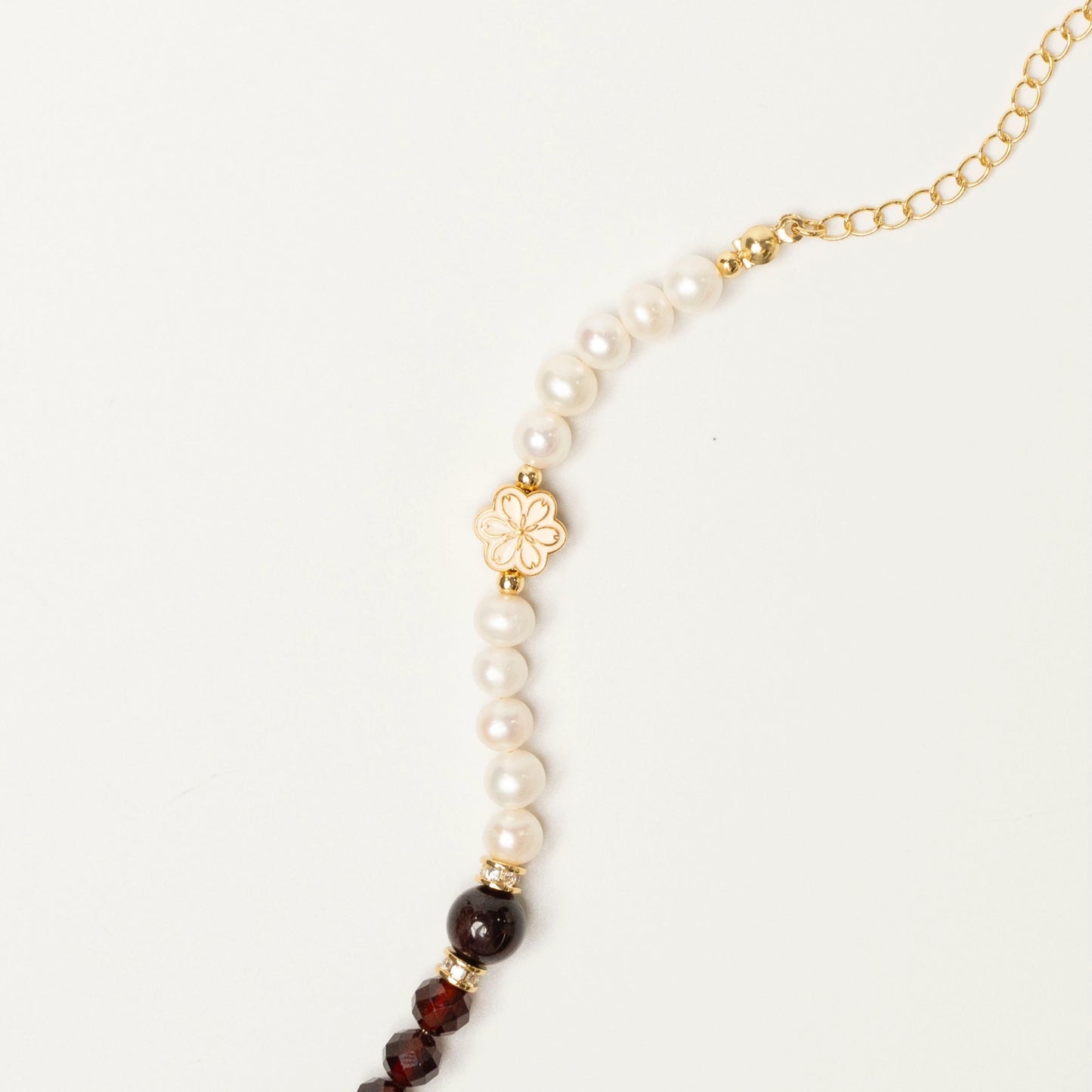 This Mulstio bracelet combines the Fire energy of garnet with the Water energy of pearl, a wearable tool for balancing the Five Elements in your life.