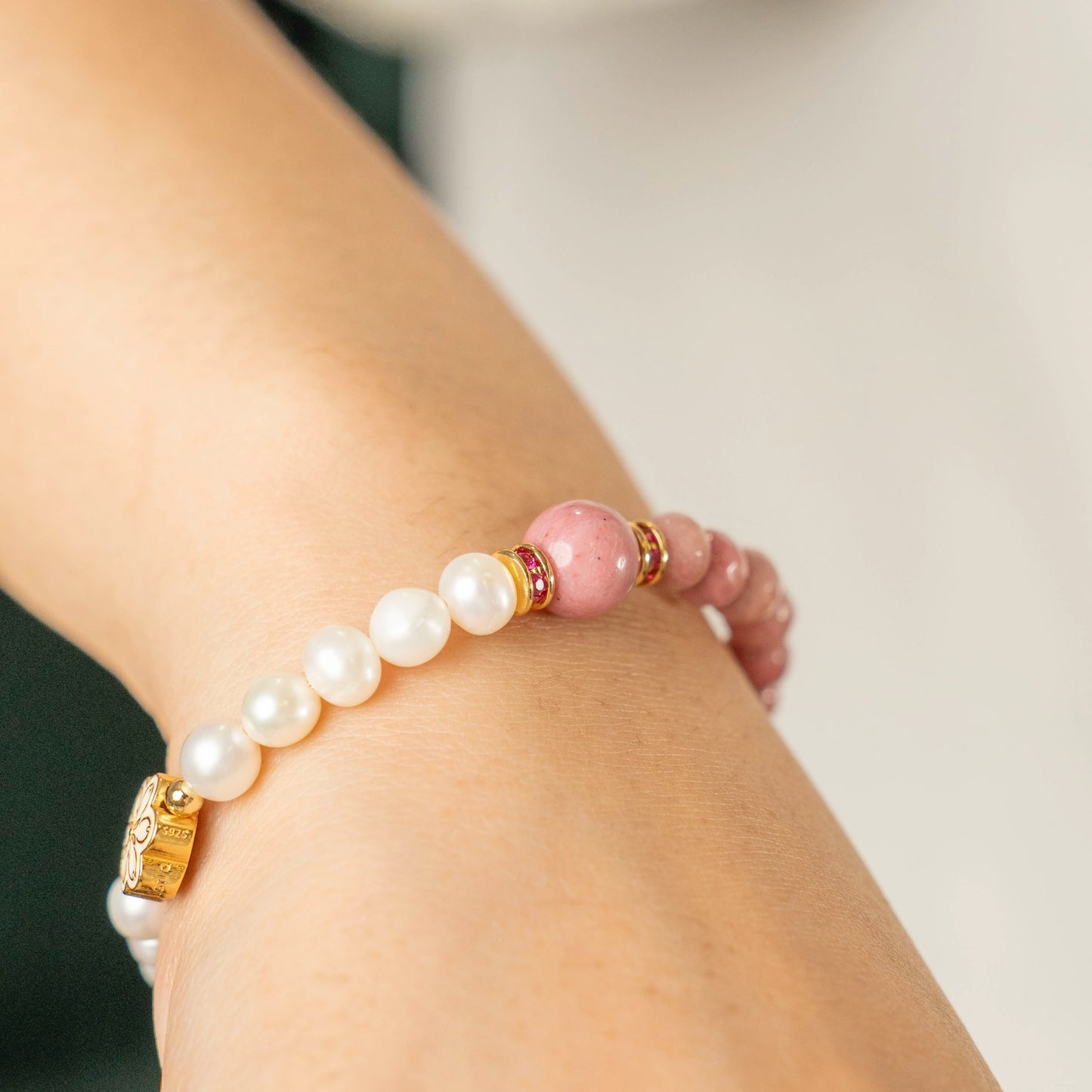 A person in a moment of quiet reflection, wearing the Mulstio Inca Rose and Pearl bracelet as a supportive companion on their journey of heart healing.