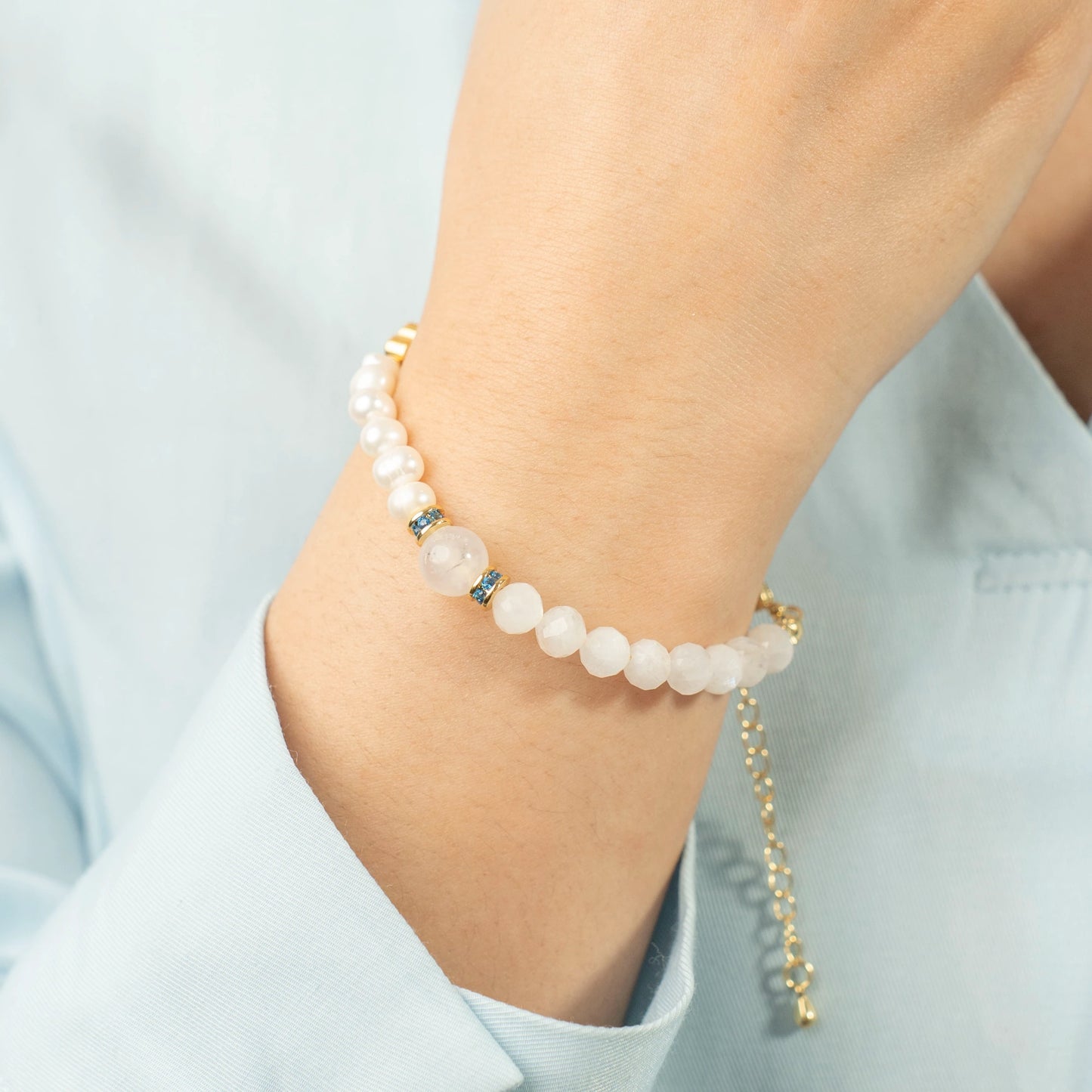 A woman moving with grace and confidence, guided by her intuition, wearing the Mulstio Moonstone and Pearl bracelet as her personal talisman.