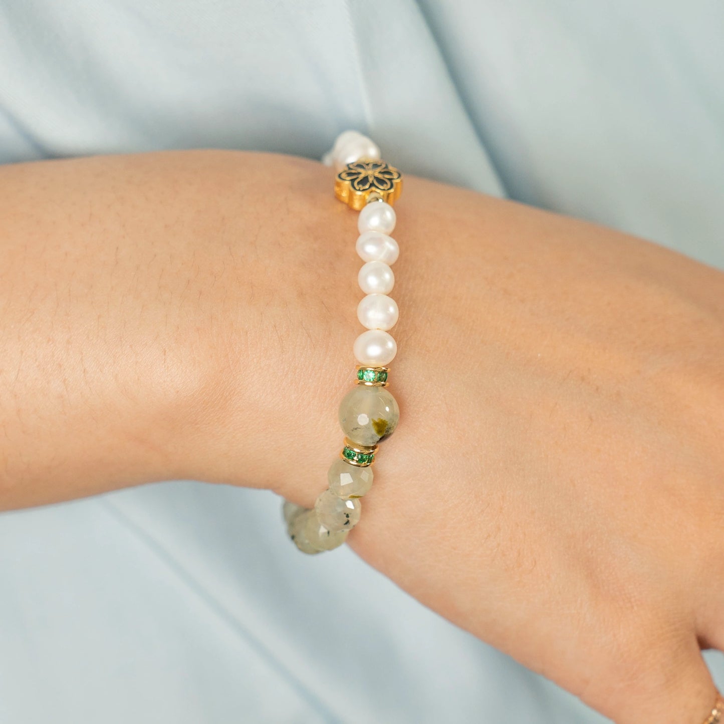 A meditator in a state of serene focus, wearing the Mulstio Prehnite and Pearl bracelet to enhance their connection to inner peace and higher guidance.