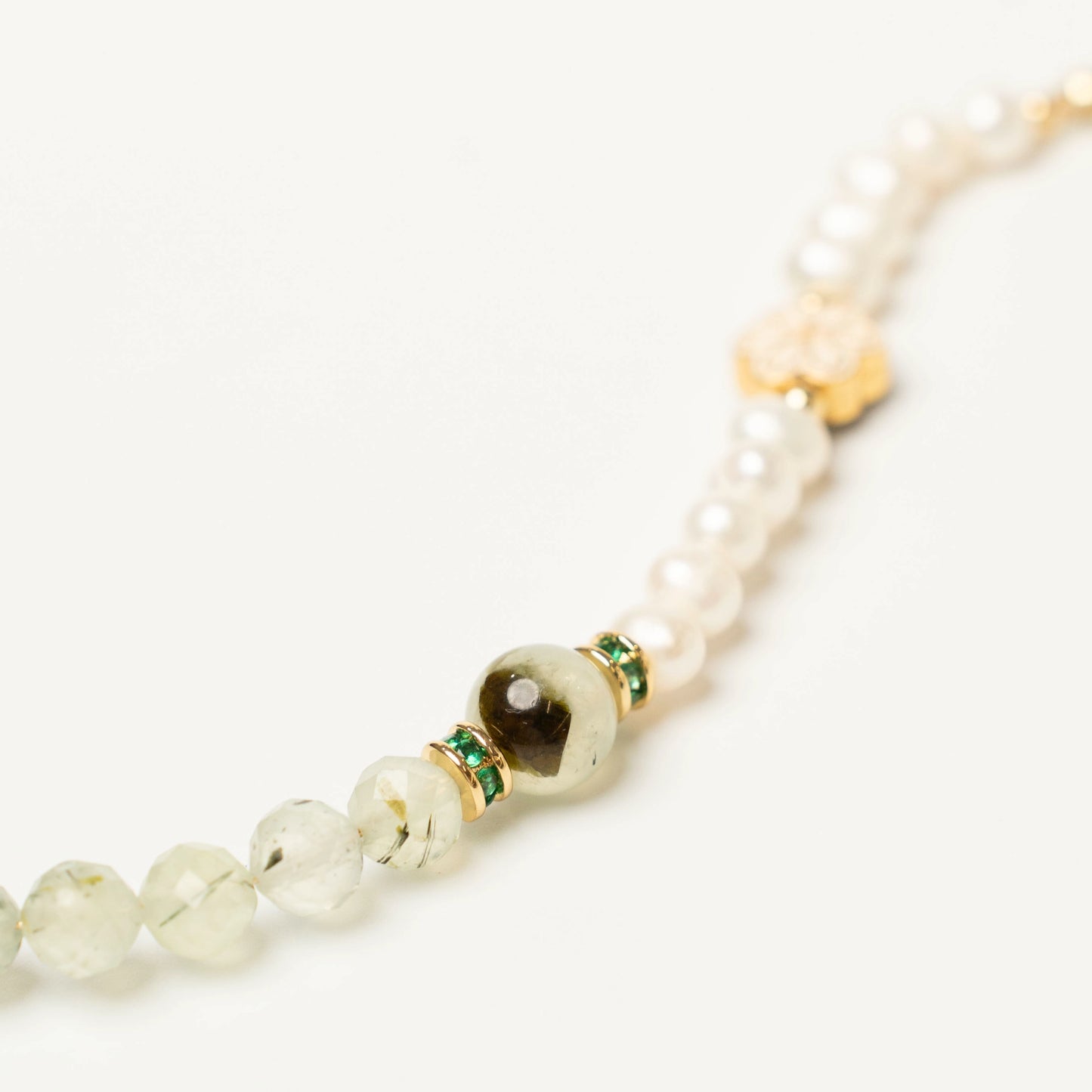 Close-up of the unique bracelet, showcasing the soothing translucent green hue of the Prehnite stone alongside the soft, luminous glow of the Pearl.