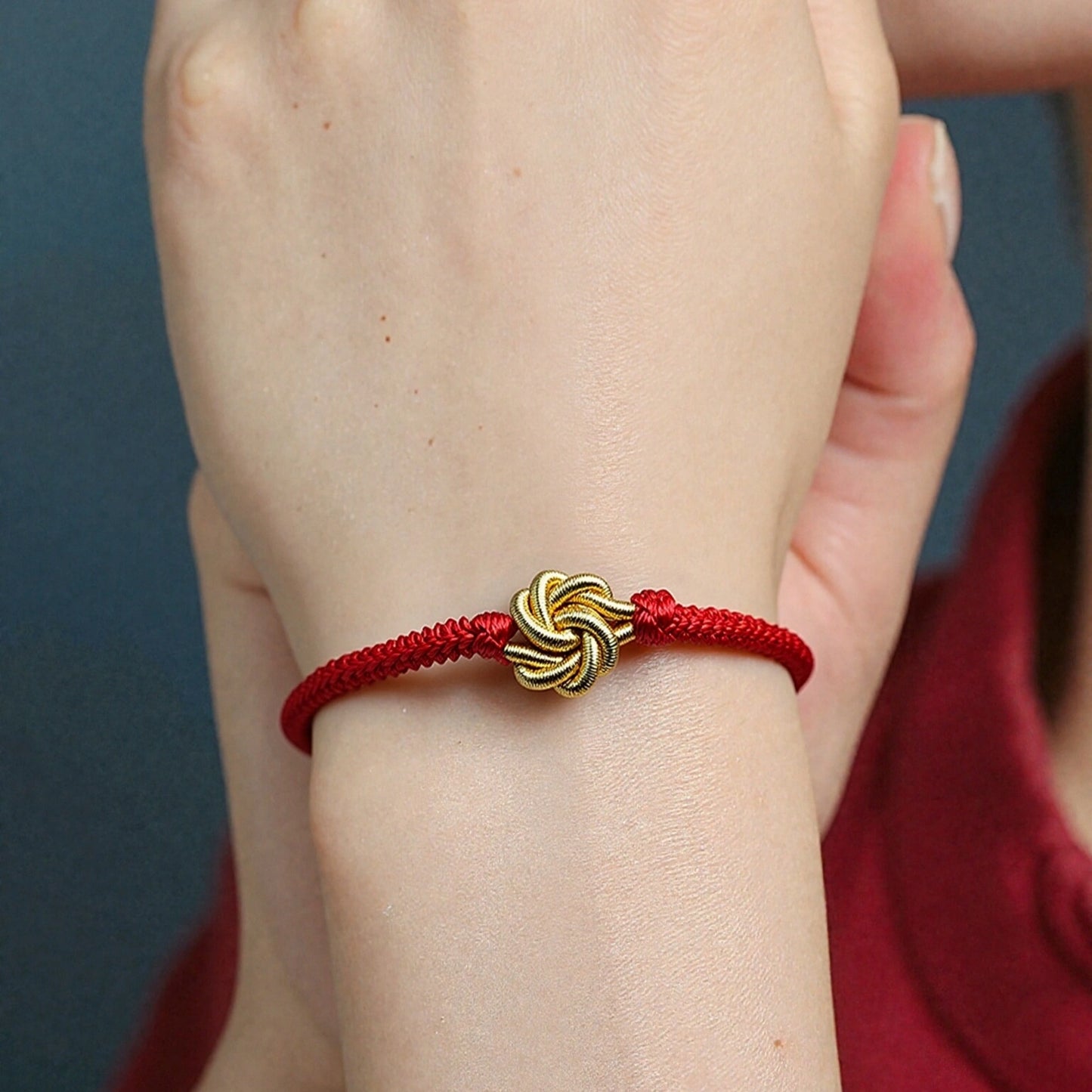 Red thread spiritual bracelet styled with casual outfit for everyday wear