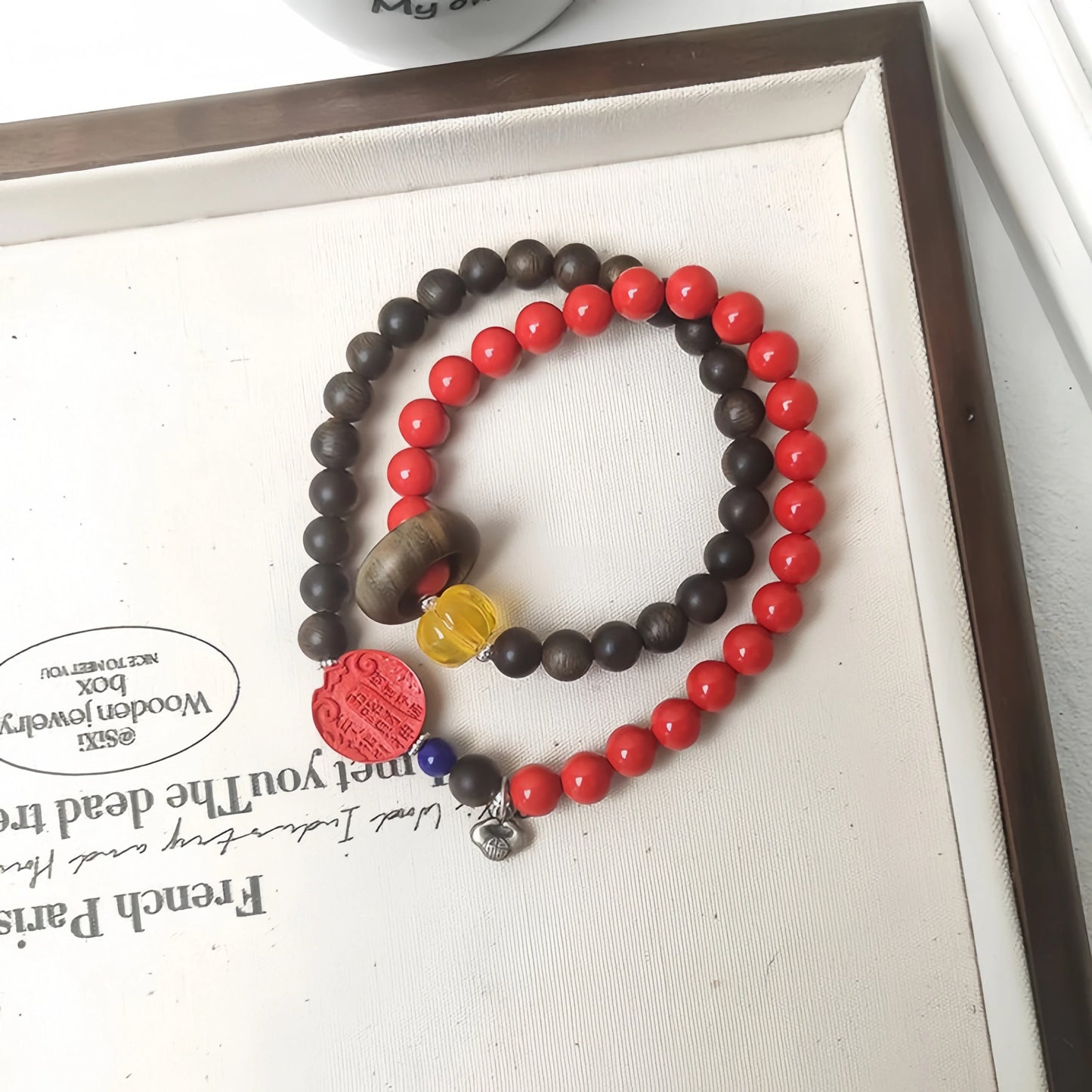 Detail of the Agarwood beads in the Mulstio wealth bracelet, showcasing their natural grain