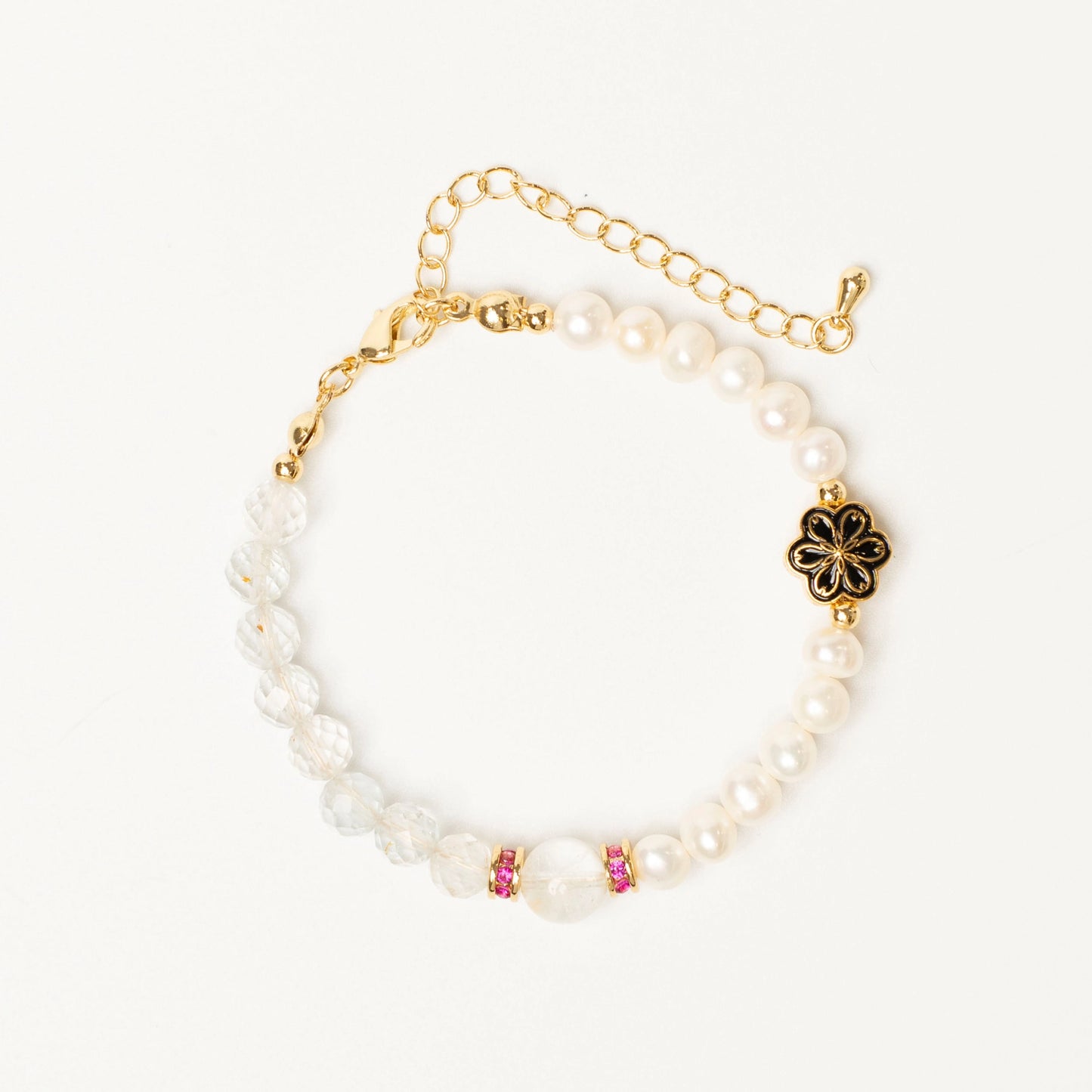 A talisman for balanced living: This Mulstio bracelet combines the activating energy of Topaz with the calming wisdom of Pearl, uniting vitality and serenity.