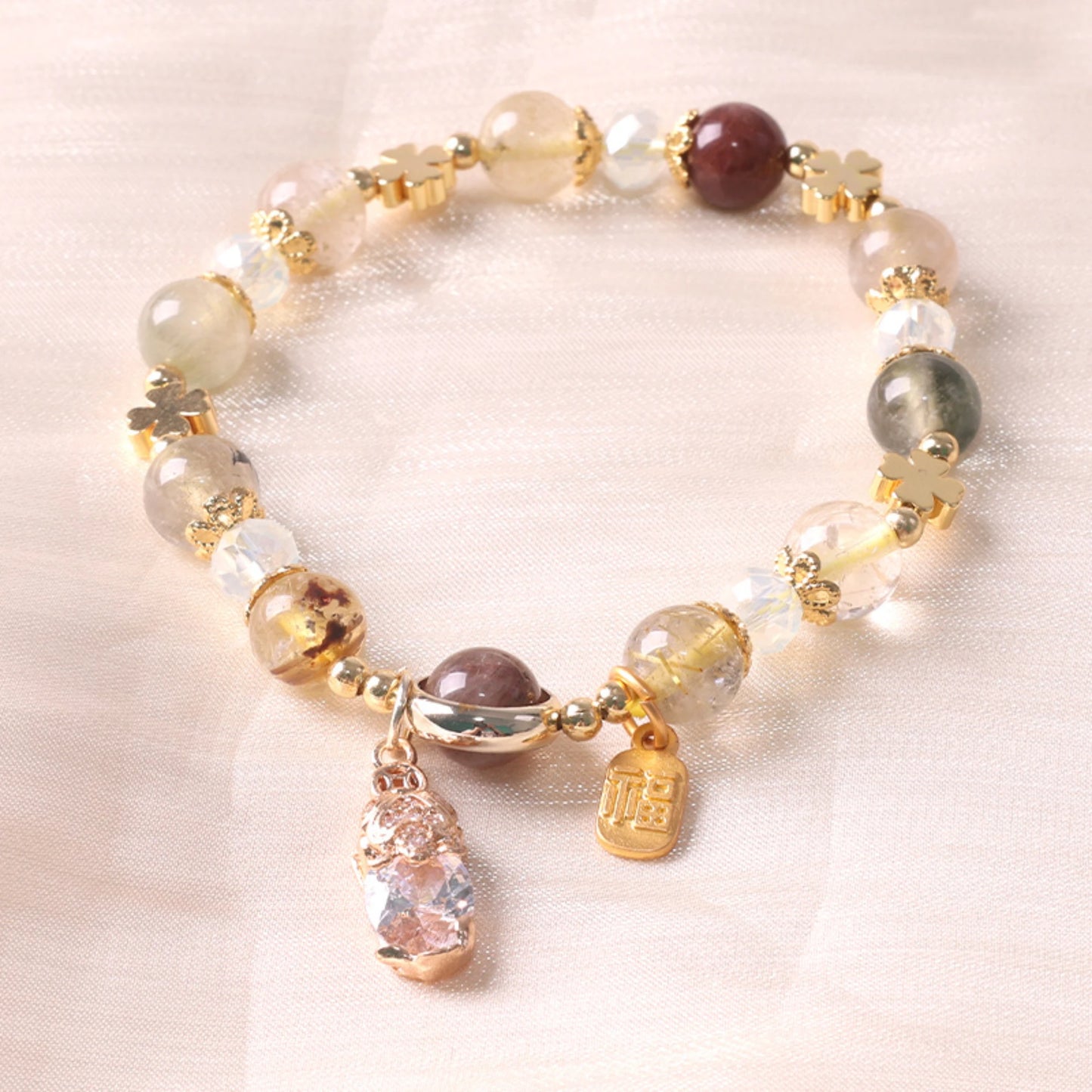 Stylized flat lay of the empowerment bracelet with yellow crystal.