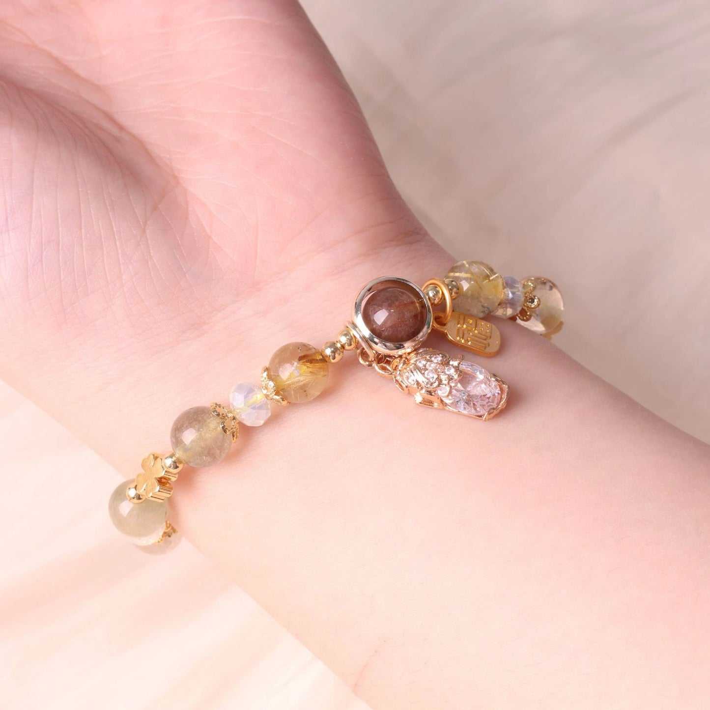 Woman wearing the Mulstio wealth bracelet in a luxury setting.