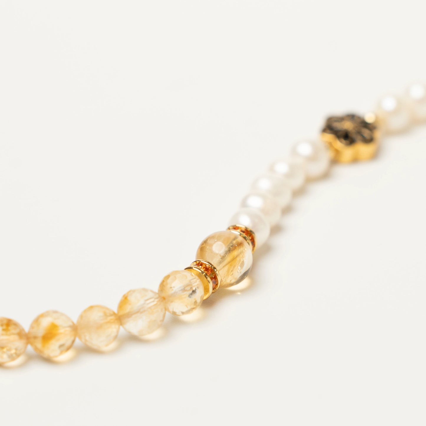 Close-up of the elegant spliced design, showcasing the warm golden hues of natural Citrine beads alternating with the soft, luminous glow of Pearls.