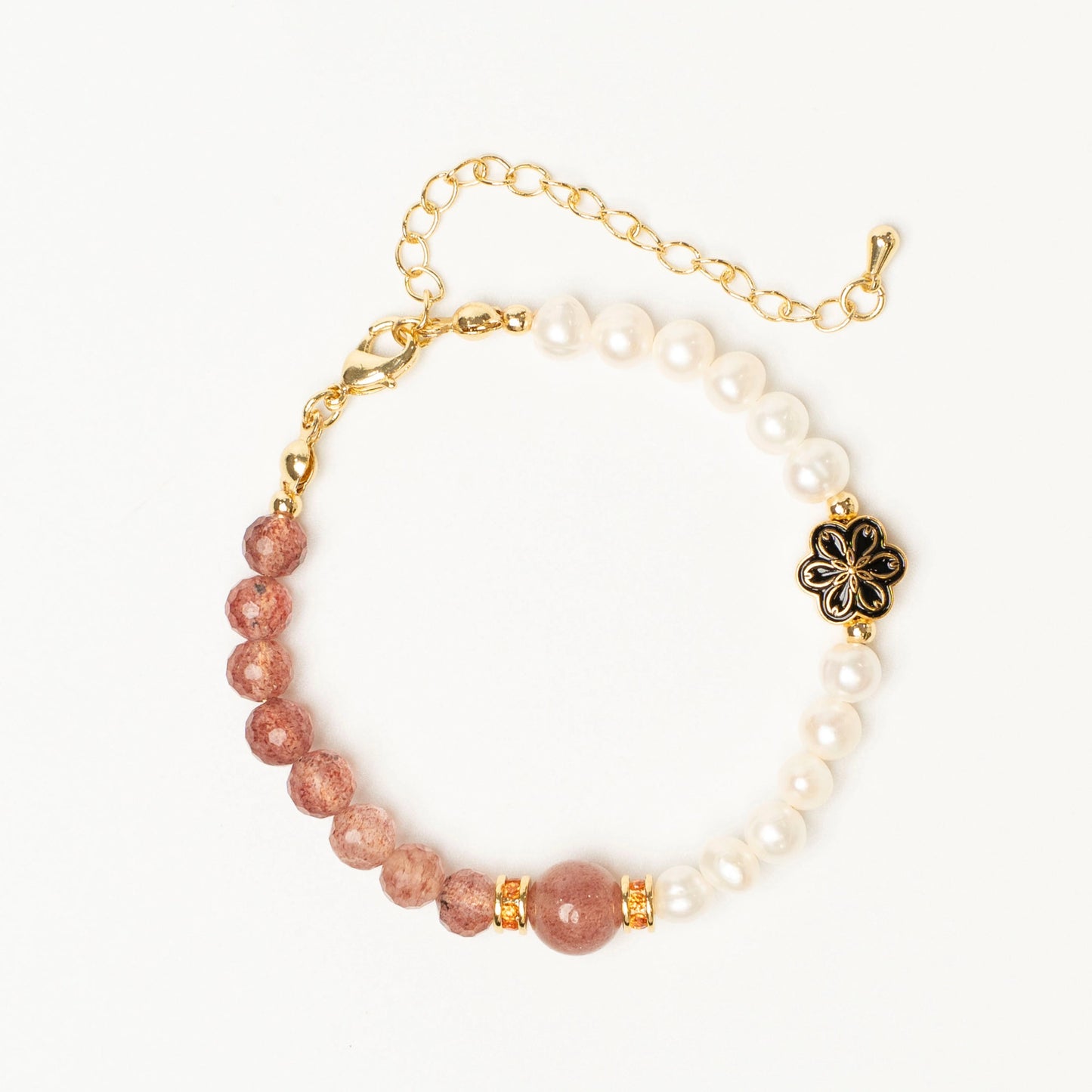 An instant mood-lifting talisman. This Mulstio bracelet uses the sweet energy of Strawberry Quartz to invoke joy and playfulness, while Pearl adds a grounding sense of grace.