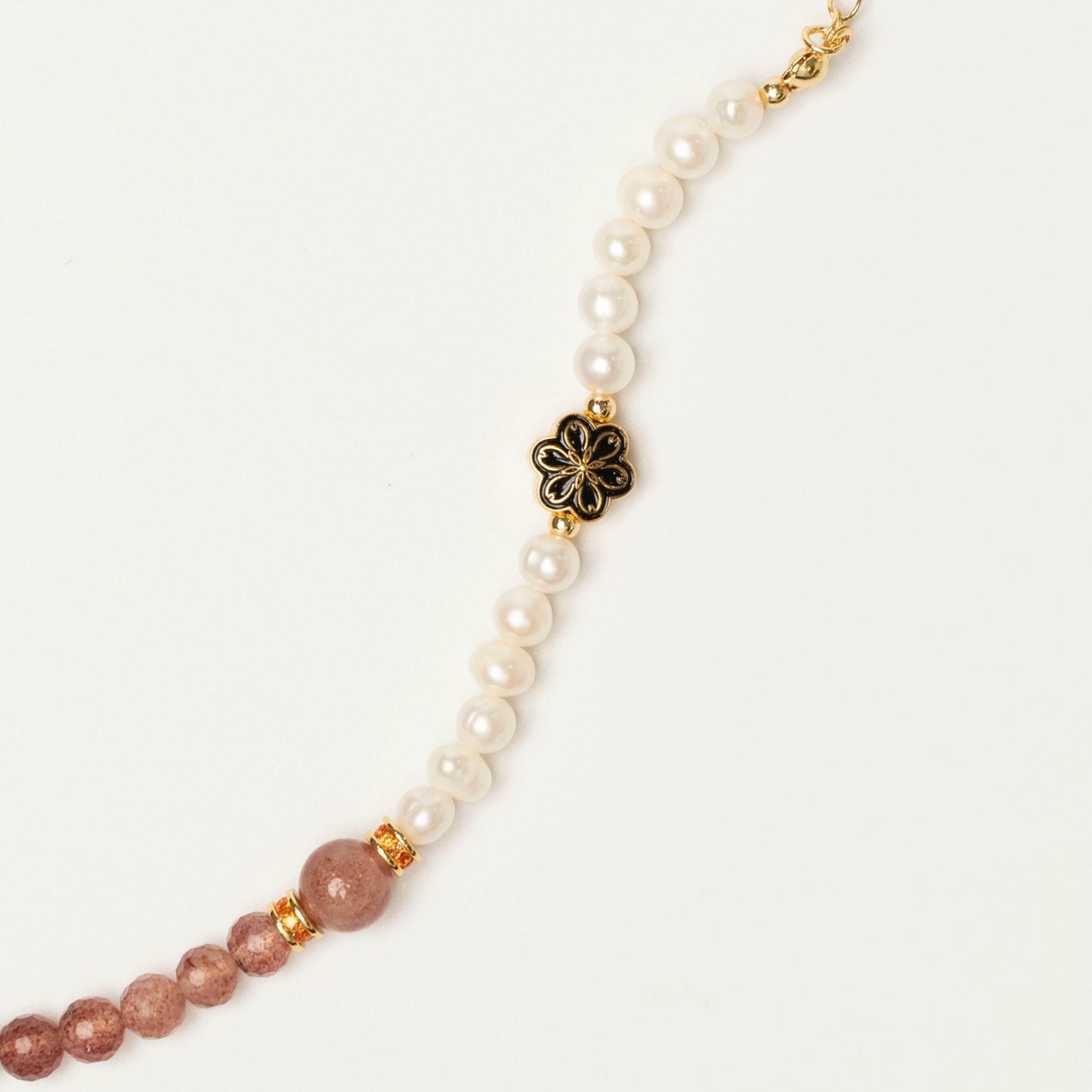 A reminder to find joy in the everyday. Wear this Mulstio bracelet to tap into the lighthearted energy of Strawberry Quartz and nurture a more optimistic outlook with Pearl.