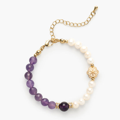 A February-born woman joyfully wearing her Mulstio Amethyst and Pearl Birthstone Bracelet, a personalized talisman for her birthday month and beyond.
