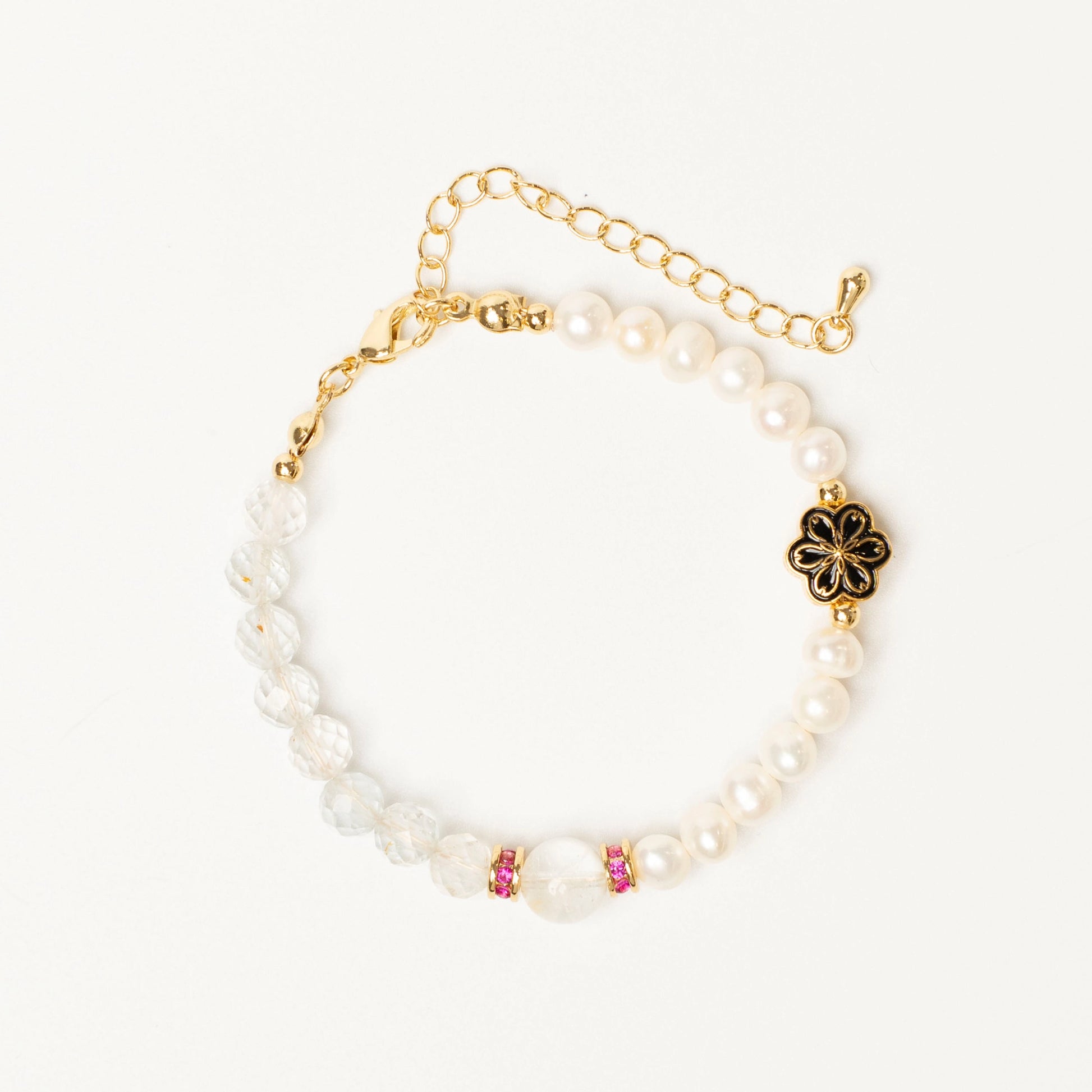 A talisman for balanced living: This Mulstio bracelet combines the activating energy of Topaz with the calming wisdom of Pearl, uniting vitality and serenity.